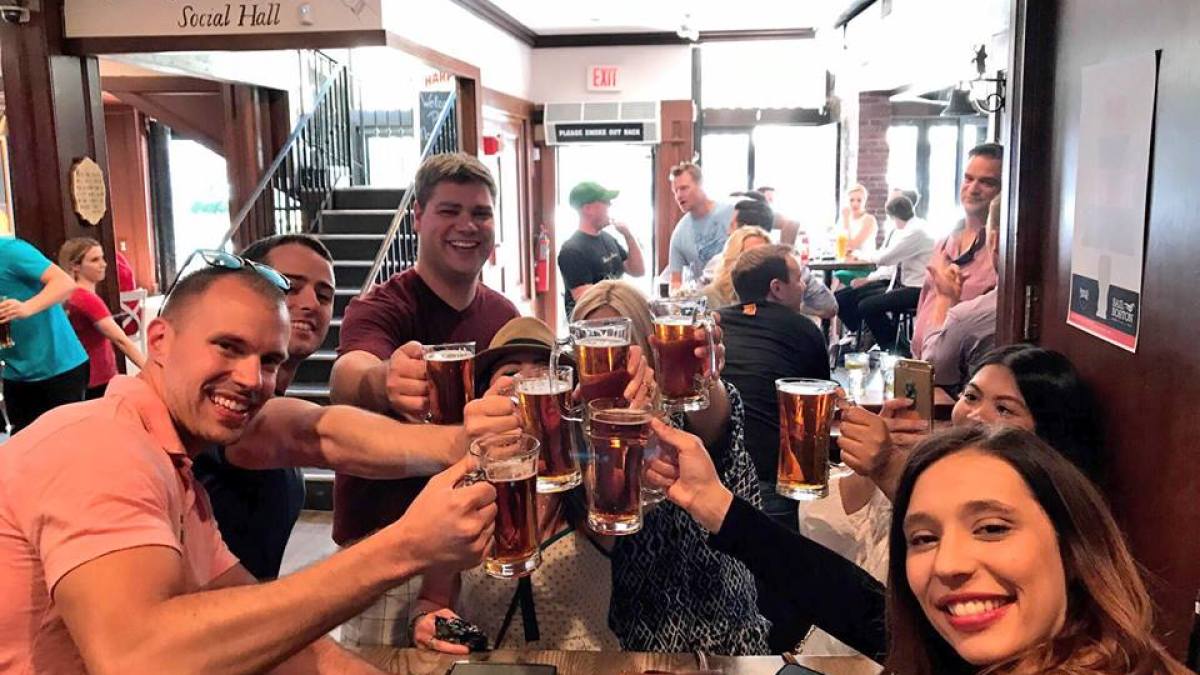 a group of people sitting at a table with wine glasses