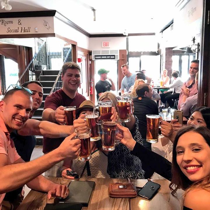 a group of people sitting at a table with wine glasses