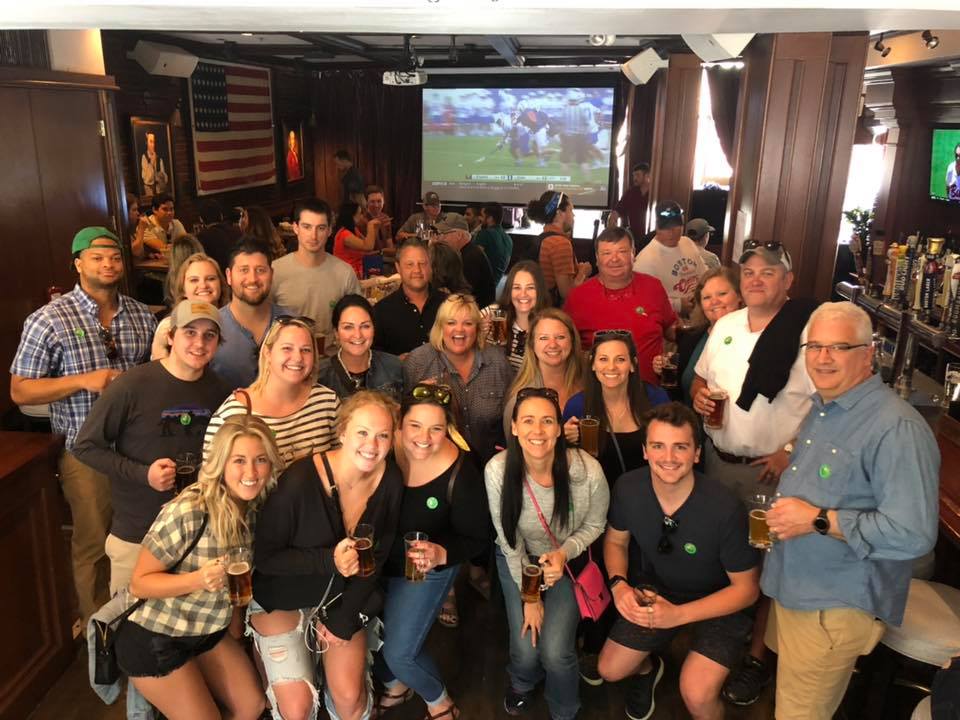Corporate – Client Outing Pub Crawl – Thumbnail Image a group of people standing in front of a crowd posing for the camera